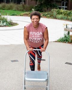 Creative Chair Yoga teacher Karen James standing behind her props.