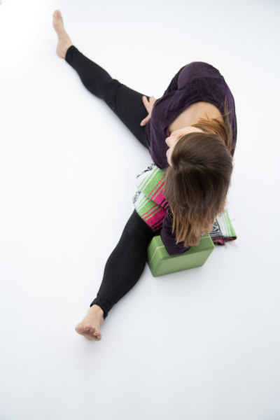 Addie deHilster practicing Lateral Dragonfly Yin pose in the Mindful Yoga Teacher Training.
