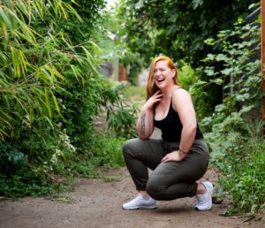 Jessica Patching-Bunch kneeling outside, practicing mindfulness in nature through green exercise.