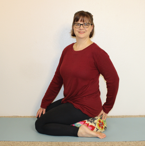 Addie deHilster sitting on a cushion teaching the movement-based mindfulness course.