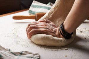 Picture of hands kneading dough, which could be a way of developing mindfulness skills.