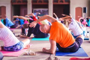 People doing a seated side stretch, illustrating alignment in yoga and mindful movement.